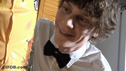 A Young Man Wearing A Bow Tie Is Smiling GIF