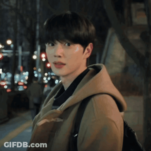A Young Man Wearing A Brown Coat And A Hooded Jacket GIF