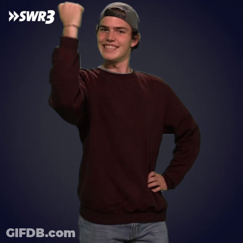 A Young Man Wearing A Brown Sweater And A Baseball Cap Holds His Fist Up In Front Of A Swr3 Logo GIF
