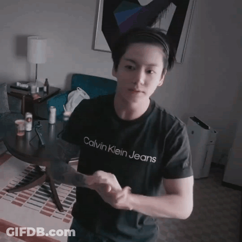 A Young Man Wearing A Calvin Klein Jeans Shirt GIF