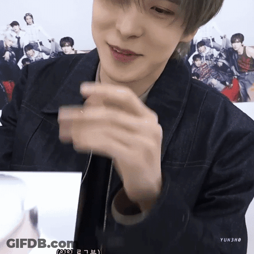 A Young Man Wearing A Denim Jacket And A Necklace With Yun3ho Written On It GIF