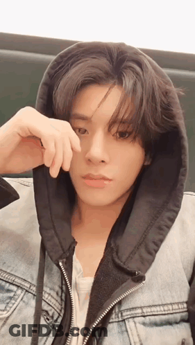A Young Man Wearing A Denim Jacket With A Black Hood Covering His Face GIF