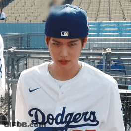 A Young Man Wearing A Dodgers Jersey And A Blue Hat GIF