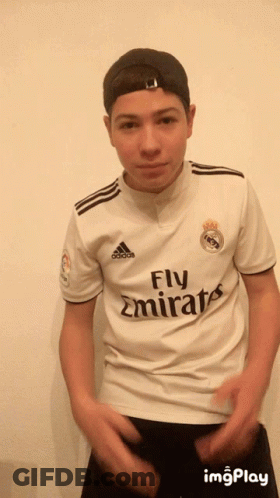 A Young Man Wearing A Fly Emirates Jersey And A Hat GIF