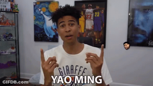 A Young Man Wearing A Giraffe Yao Ming Shirt Is Making A Funny Face GIF