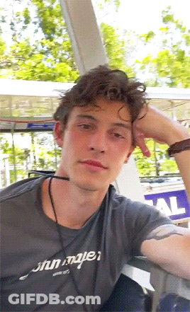 A Young Man Wearing A Gray Shirt That Says John Mayer On It GIF