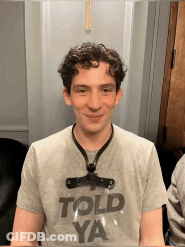 A Young Man Wearing A Gray Shirt That Says Told Ya GIF