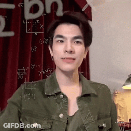 A Young Man Wearing A Green Jacket Is Standing In Front Of A Chalkboard With Mathematical Equations On It . GIF