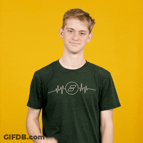 A Young Man Wearing A Green Shirt With A Heartbeat And The Letter S On It GIF