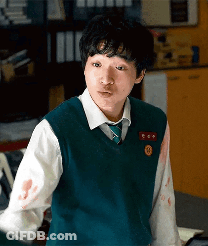 A Young Man Wearing A Green Vest And Tie Has Blood On His Sleeves GIF
