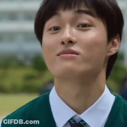 A Young Man Wearing A Green Vest And Tie Looks Up At Something GIF