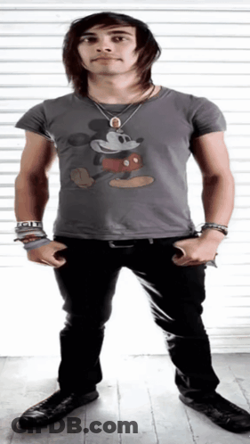 A Young Man Wearing A Grey Mickey Mouse Shirt GIF