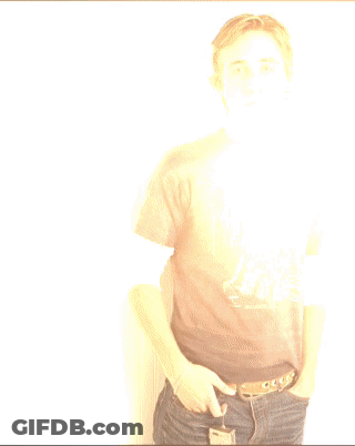 A Young Man Wearing A Harley Davidson T-Shirt Stands With His Hands In His Pockets GIF