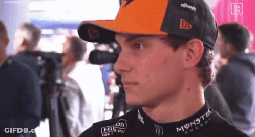 A Young Man Wearing A Hat And A Black Shirt With Monster Energy On It . GIF