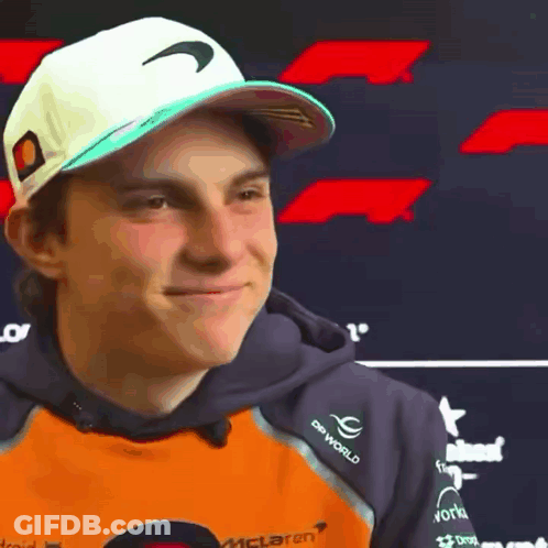 A Young Man Wearing A Hat And A Hoodie With The Word Mclaren On It . GIF
