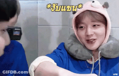 Young Men Talking With Hat And Neck Pillow GIF