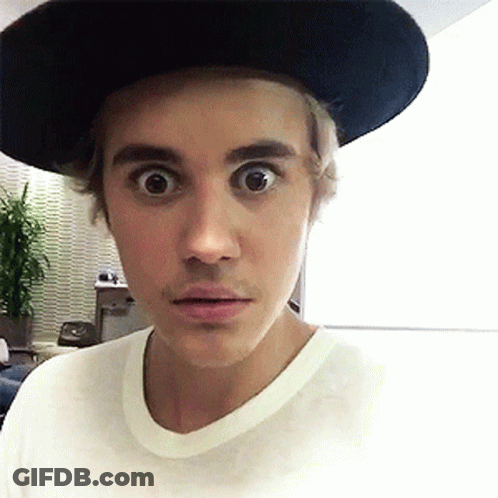 A Young Man Wearing A Hat And A White Shirt Looks Surprised GIF