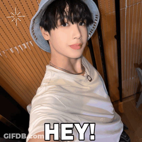 A Young Man Wearing A Hat And A White Shirt Says " Hey " GIF