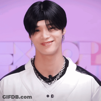 A Young Man Wearing A Headband And A Necklace Smiles GIF