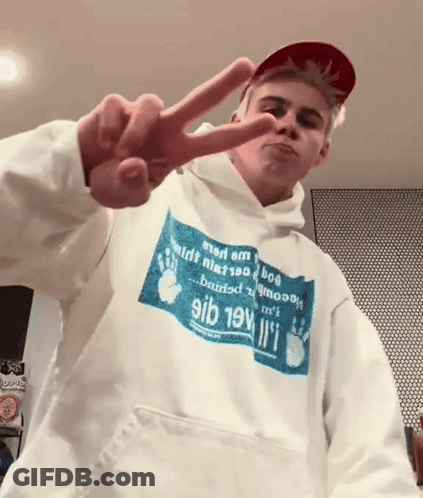 A Young Man Wearing A Hoodie That Says 9Ib 19V Giving A Peace Sign GIF
