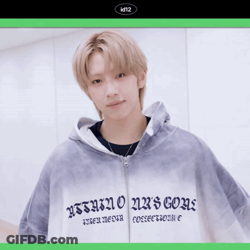 A Young Man Wearing A Hoodie That Says Id12 Holds A Red Rose In His Hand GIF