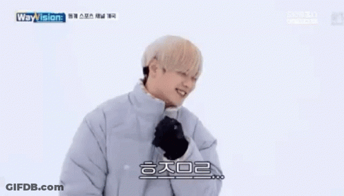 A Young Man Wearing A Jacket And Gloves Is Smiling . GIF