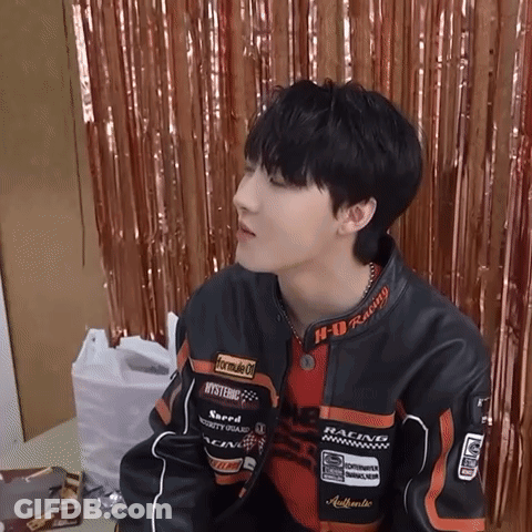 A Young Man Wearing A Jacket That Says Formula 1 On It GIF