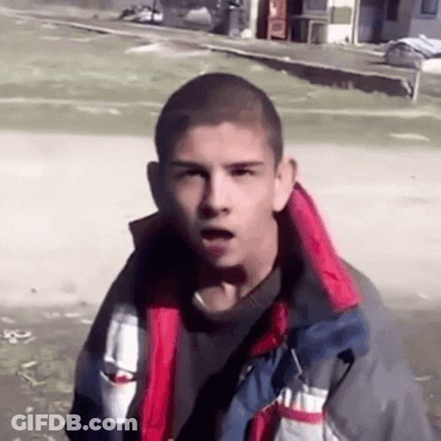 A Young Man Wearing A Jacket With A Red And White Striped Collar GIF