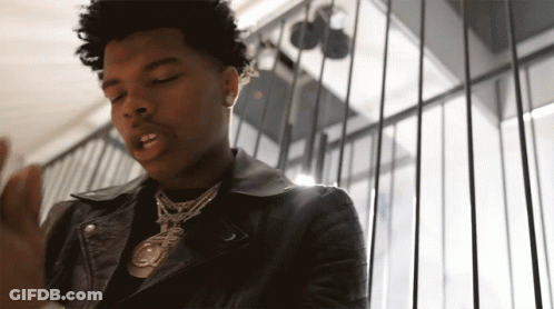 A Young Man Wearing A Leather Jacket And A Necklace With A Pendant That Says ' A ' On It GIF