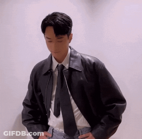 A Young Man Wearing A Leather Jacket And Tie GIF