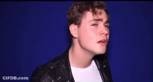 A Young Man Wearing A Leather Jacket And White Shirt GIF