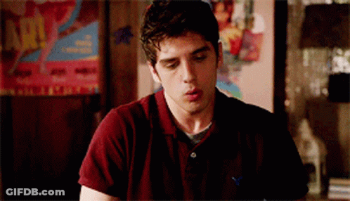 A Young Man Wearing A Maroon Shirt With An American Eagle On The Front GIF