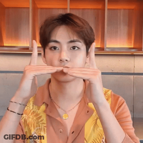 A Young Man Wearing A Necklace And A Shirt Is Making A Funny Face GIF