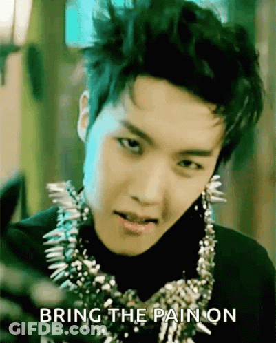 A Young Man Wearing A Necklace With Spikes And The Words Bring The Pain On Behind Him GIF