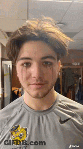 A Young Man Wearing A Nike Shirt Has Tears Running Down His Face GIF