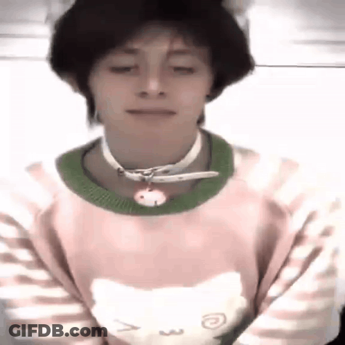 A Young Man Wearing A Pink Sweater With A Cat On It And A Choker . GIF