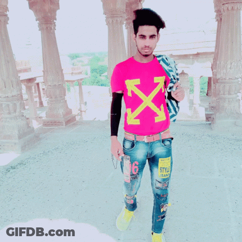 A Young Man Wearing A Pink T-Shirt With Arrows On It GIF