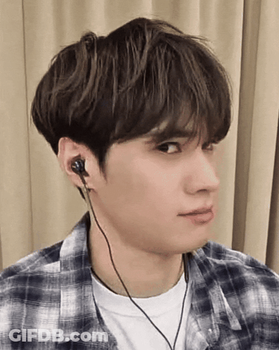 A Young Man Wearing A Plaid Shirt And Headphones GIF
