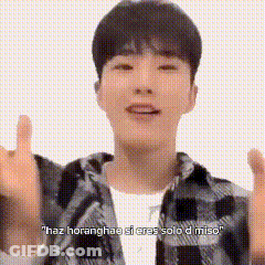 A Young Man Wearing A Plaid Shirt Is Giving A Thumbs Up . GIF