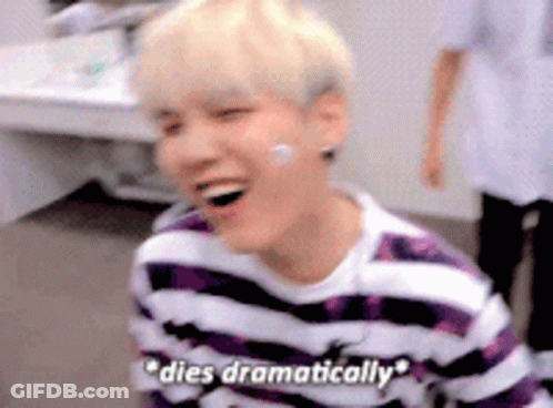 A Young Man Wearing A Purple And White Striped Shirt Is Laughing And Says `` Dies Dramatically '' . GIF