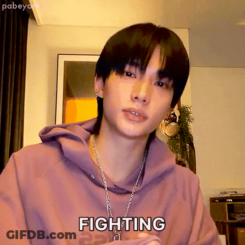 A Young Man Wearing A Purple Hoodie And A Chain Necklace Says Fighting GIF
