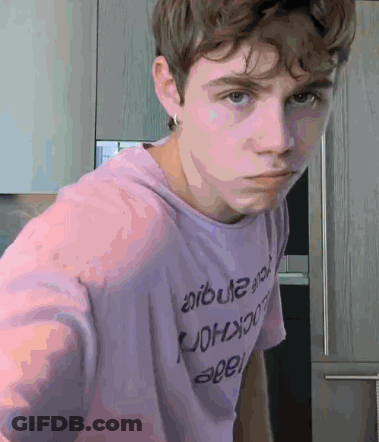 A Young Man Wearing A Purple T-Shirt That Says ' Aruba ' On It GIF