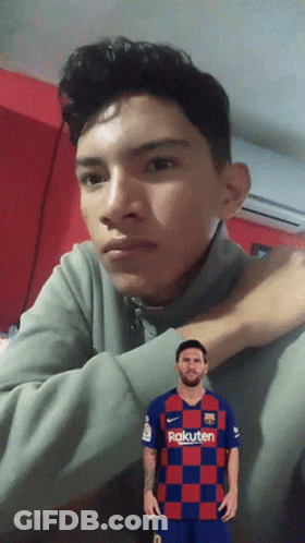 A Young Man Wearing A Rakuten Shirt Looks At The Camera GIF