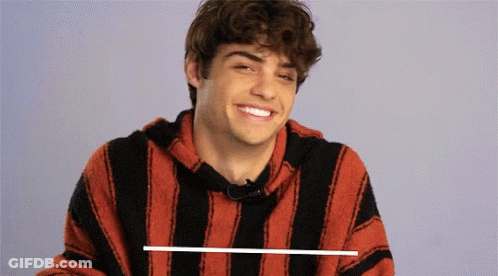 A Young Man Wearing A Red And Black Striped Shirt Smiles GIF