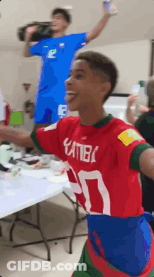 A Young Man Wearing A Red And Blue Shirt With The Number 30 On It GIF