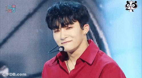 A Young Man Wearing A Red Shirt With A Microphone On His Neck GIF