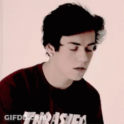 A Young Man Wearing A Red Thrasher Skateboard Magazine T-Shirt GIF