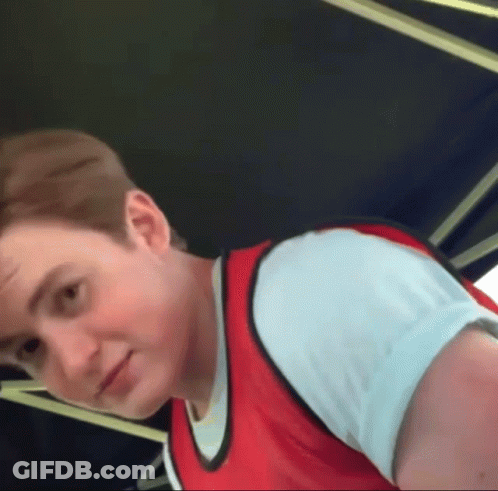 A Young Man Wearing A Red Vest And White Shirt GIF