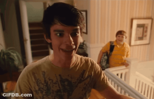 A Young Man Wearing A Shirt That Says ' Rock ' On It Smiles GIF