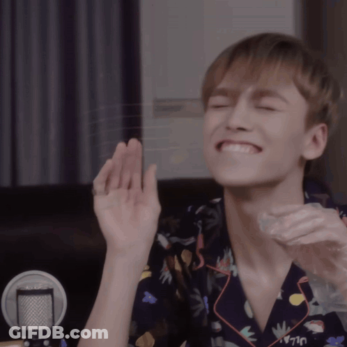 A Young Man Wearing A Shirt That Says Uljay Is Smiling With His Eyes Closed GIF